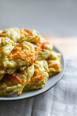 vegetarian Zucchini Fritters on a grey plate, grey background