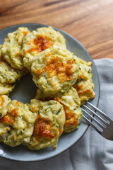 vegetarian Zucchini Fritters on a grey plate, grey background