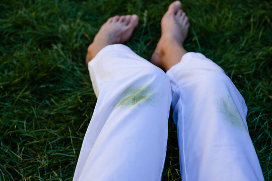 Girl's Bare Feet In The Grass In The Open.dirty Grass Stains On Women's Pants.daily Life Dirty Stain For Wash And Clean Concept