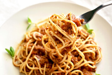 Spaghetti Bolognese with minced beef, onion, chopped tomato, garlic, olive oil, stock cube, tomato puree and Italian herb. Traditional Italian food.