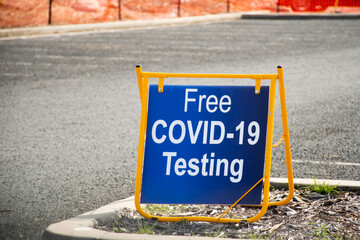 Free COVID-19 testing. Drive through testing clinic sign on a road