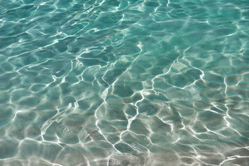 Sun reflections on the crystal clear sea water