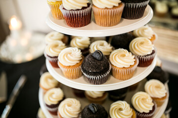 small chocolate and vanilla cupcakes on cake stand 