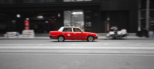 Fototapeta na wymiar cars on the road red taxi hongkong in a rush speed movement moving forward empty roads