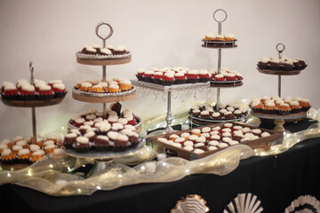 small cupcakes on cake stand in soft light at reception
