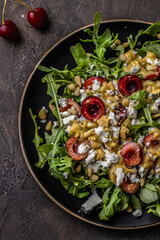 Salad with arugula, cherries, goat cheese, pine nuts, mustard -olive oil dressing
