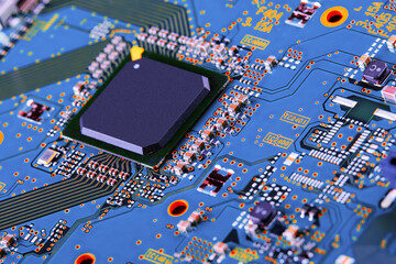 Electronic circuit board with electronic components such as chips close up. Blurry background.	
