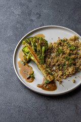 roasted broccoli with quinoa and pomegranate sauce. Top view. Copy space