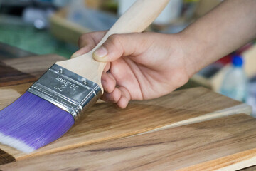 A carpenter paint brush used to improve and close the color of the wood to be beautiful.