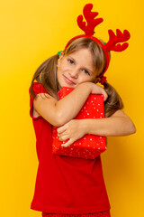 Little girl hugging Christmas present