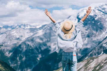 Unrecognizable woman enjoying freedom in mountains