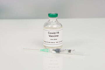 Close up of a syringe and a Covid-19 serum/vaccine bottle