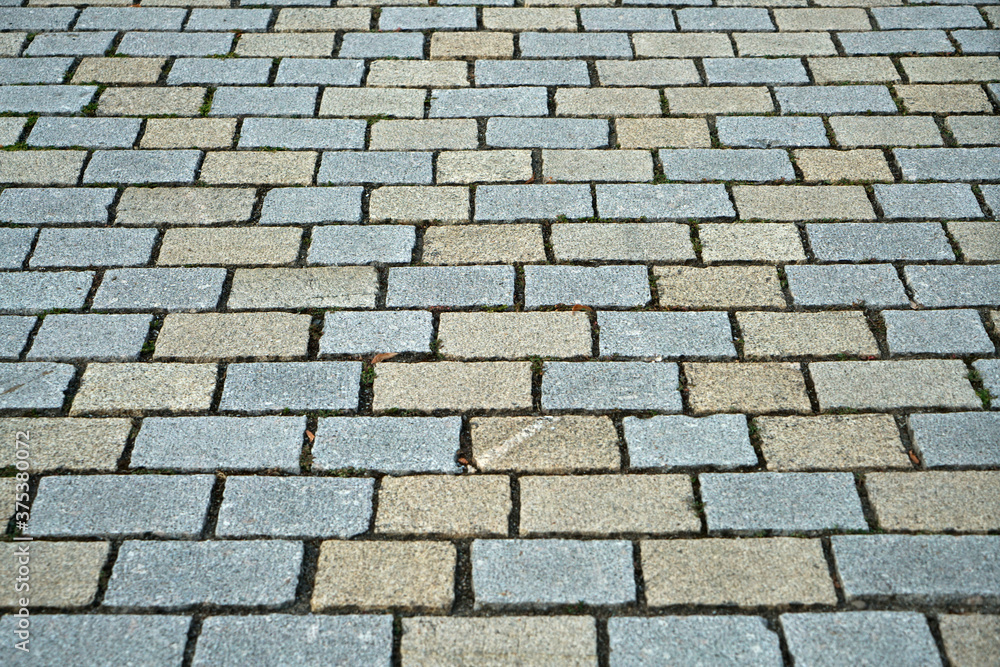 Poster closeup shot of an abstract background of a cobblestone