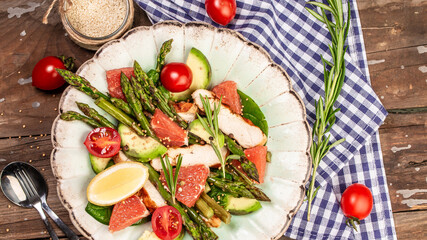 delicious dish asparagus and salad, chicken, avocado, tomato. Top view