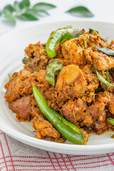 Indian Style Spicy Stir-Fried Chicken with Curry Leaves and Green Chilies Close Up Photo