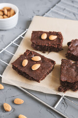 Homemade chocolate brownie with almond nut served on a metal tray. Traditional chocolate dessert