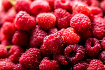 Fresh and sweet red raspberries texture. fruit pile background