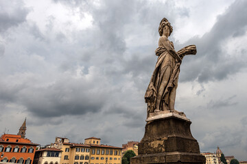 Fototapeta na wymiar Florence, marble statue, symbol of summer, on the Ponte Santa Trinita (Ancient bridge, XVI century), sculptor Giovanni Battista Caccini (1556-1613). Tuscany, Italy, Europe