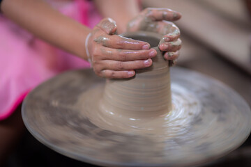 Woman hand working on the potter's wheel