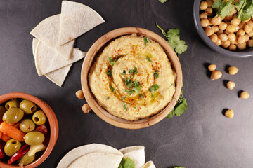 hummus with pita bread and olives