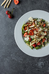 Healthy salad with strawberry, white asparagus, arugula, parmesan cheese. Top view. Copy space