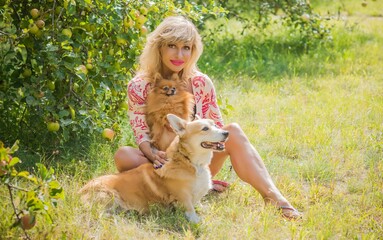 Woman with nice dog of Corgi breed for a walk . The life of dogs. Pet are best friend 