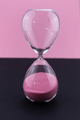 The concept of passing time, urgency and lack of time. Sand falls into the hourglass. The deadline...