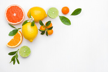 Background made of citrus fruits on white table with copyspace
