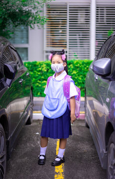 Thai Girl Student Wearing A Mask Against Coronavirus And PM 2.5 Air Pollution Before Going To School