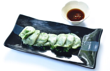 steamed Chinese rice flour dumpling stuffed fried chop garlic chives on plate dipping soy sauce
