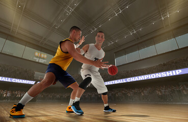 Basketball players on big professional arena during the game.