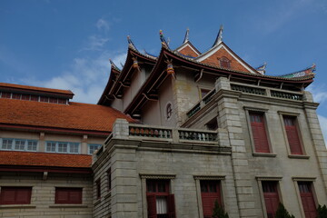 Ancient buildings of Xiamen University in Fujian University under blue sky.