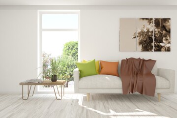 White stylish minimalist room with sofa and summer landscape in window. Scandinavian interior design. 3D illustration