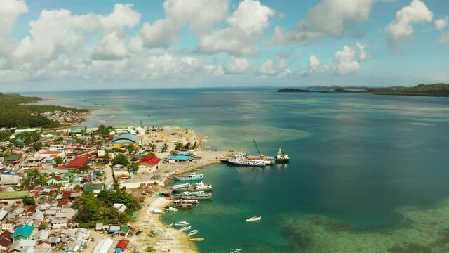 Freight ships and ferries in the bay, top view. Dapa Ferry Terminal. Siargao, Philippines.