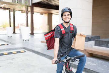 Handsome Delivery Man Holding Paper Bag