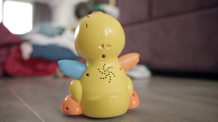 Child toy moving on floor. Toy duck drive on floor in baby room. Kid toys
