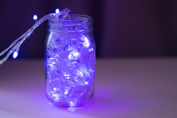 Lights inside the glass jar, colorful light glowing in the dark inside the jar. selective focus