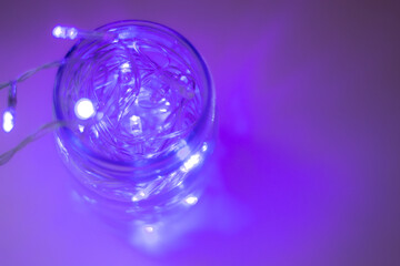 Lights inside the glass jar, colorful light glowing in the dark inside the jar. selective focus