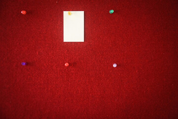 collection of note papers pinned on a red board ready for filling in quotes.