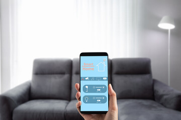hand holding mobile phone with smart home screen