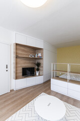 White modern minimalistic living room with yellow sofa conected with bedroom