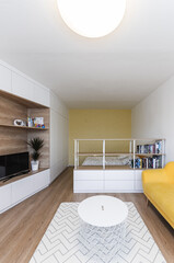 White modern minimalistic living room with yellow sofa conected with bedroom