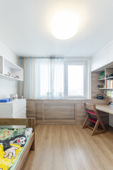 Children's room with table, bed and cabinets