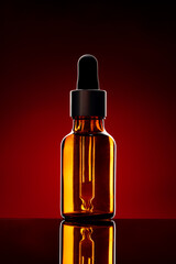 Glass bottle with cosmetic oil on dark background