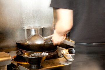 炒め物をする調理師の手元