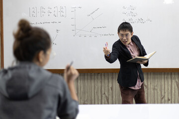 Asian teacher is teaching students in the classroom.