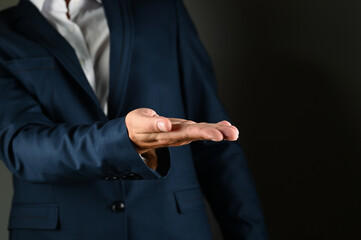 Man in a suit with outstretched arm imitating support