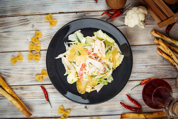 Salad with pineapple crab sticks and greens