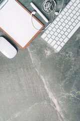 Business composition with white computer keyboard, mouse, clipboard, paper on marble background. Coffee break concept. Top view with copy space for text. Flat lay, mock up