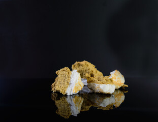 Pieces of cloud bread on black glass. Dessert made from sugar and eggs.